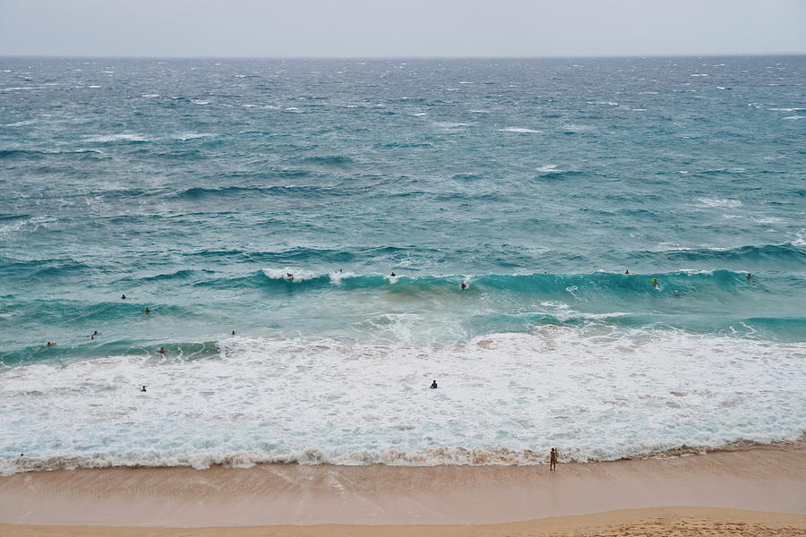 Crowded surfers riding Oahu Island beach waves Photograph by Marek Poplawski