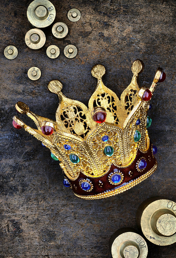 Crown, weights and coins on stone surface Photograph by Looking Glass