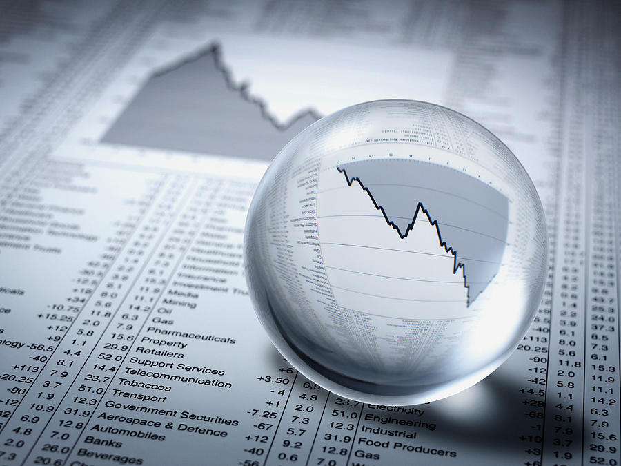 Crystal ball, descending line graph and share prices Photograph by Adam Gault