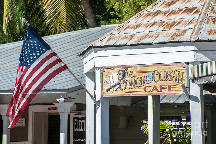 Black And White Photograph - Cuban Cafe and American Flag Key West by Ian Monk