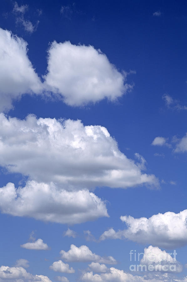 Cumulus clouds in blue sky  Photograph by Jim Corwin