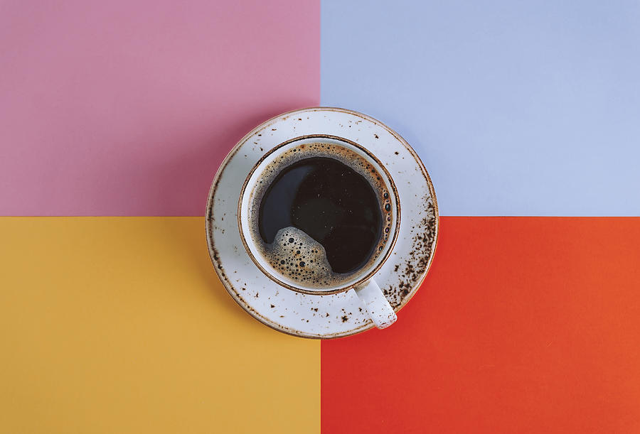 Cup of Coffee on colored background Photograph by Oxygen