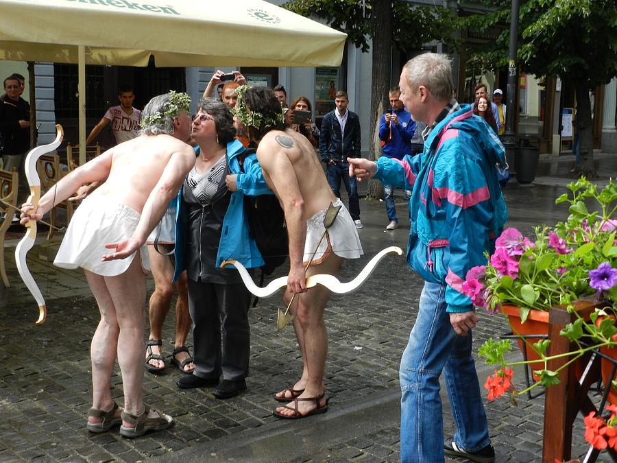 Street Theater Photograph - Cupids Conquer a German Tourist by ITI Ion Vincent Danu