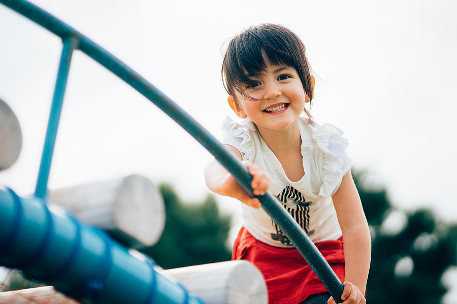 Cute 3 year old mixed race girl having fun at playground Photograph by Ippei Naoi