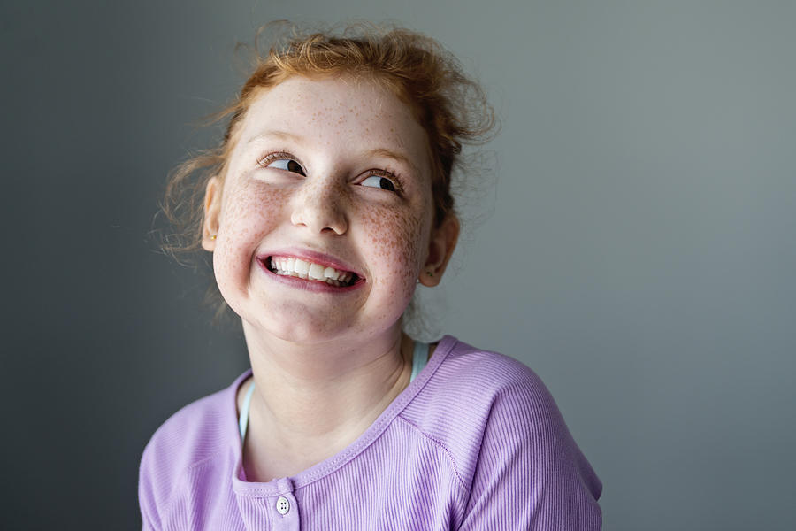 Cute and expressive preteen girl with redhead portrait. Photograph by Martinedoucet