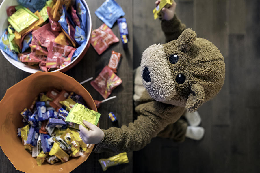 Cute Baby Boy inside Bear Costume Eating or Grabbing Candies Photograph by Onfokus