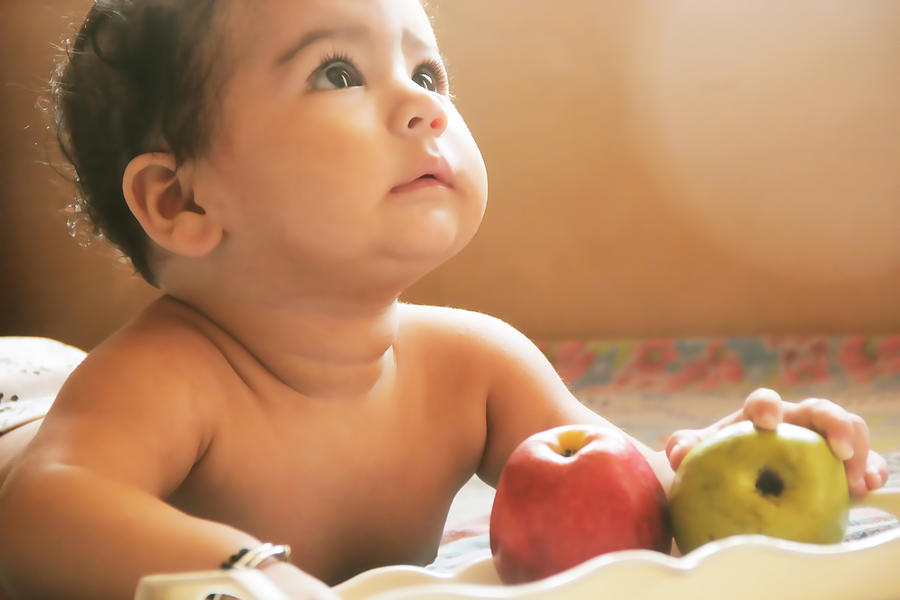 Cute baby eating fruits Photograph by Triloks