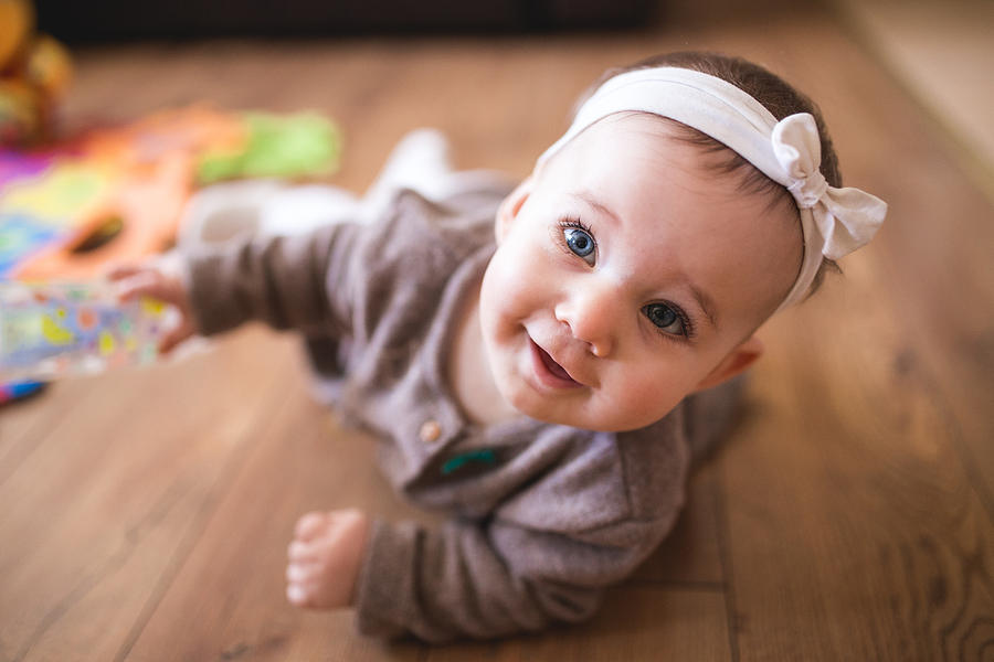 Cute Baby Girl Crawling In Living Room Photograph by Kosamtu