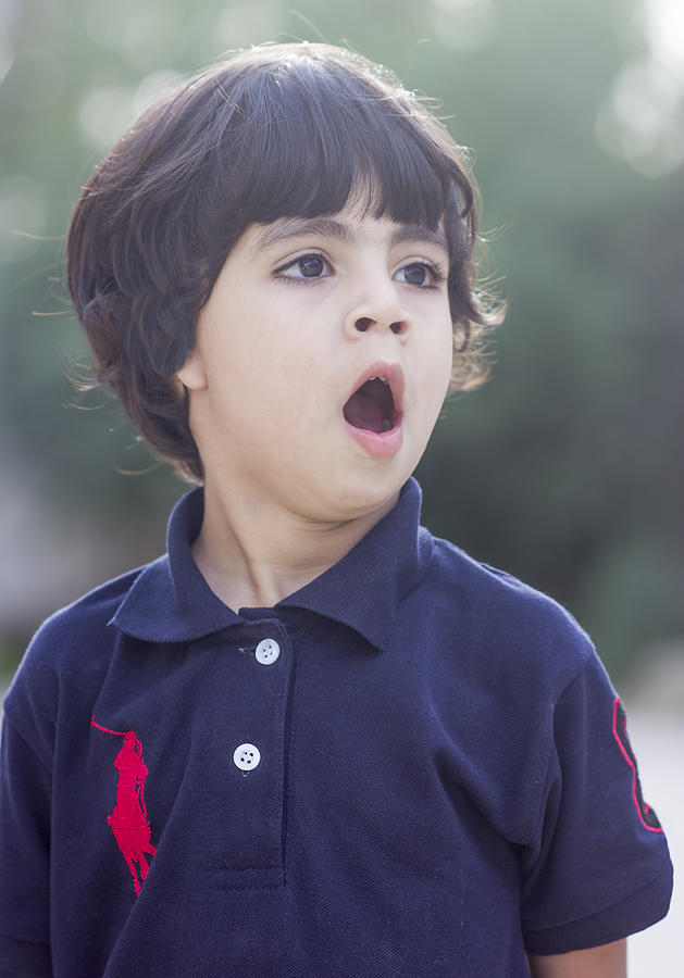Cute boy yawning Photograph by Riaz Baloch