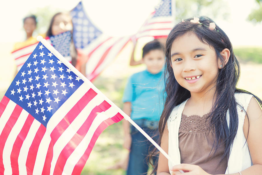 Cute Filipino girl holds American flag outdoors Photograph by Steve Debenport