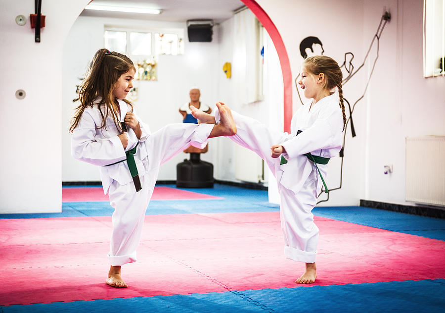 Cute girls on Taekwondo training Photograph by Drazen_