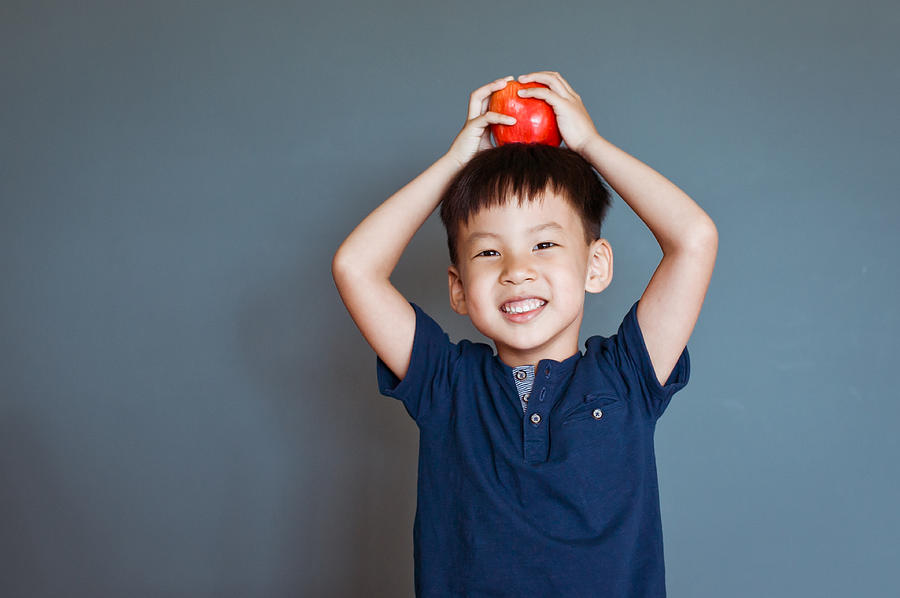 Cute little boy with an apple on his head. Photograph by Clover No.7 Photography