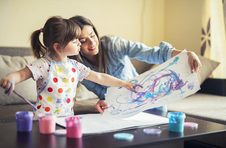 Cute Little Girl Painting With Mommy Together At Home, Portrait Of Mother And Daughter Painting At Home Photograph by ArtistGNDphotography
