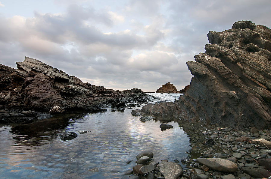 Cala Mesquida in Minorca north coast offers us an amazing landscape of Cutting rocks Photograph by Pedro Cardona Llambias