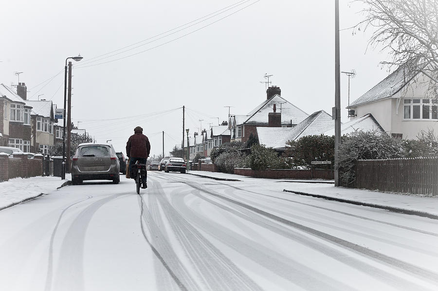 Architecture Photograph - Cyclist in the snow by Tom Gowanlock