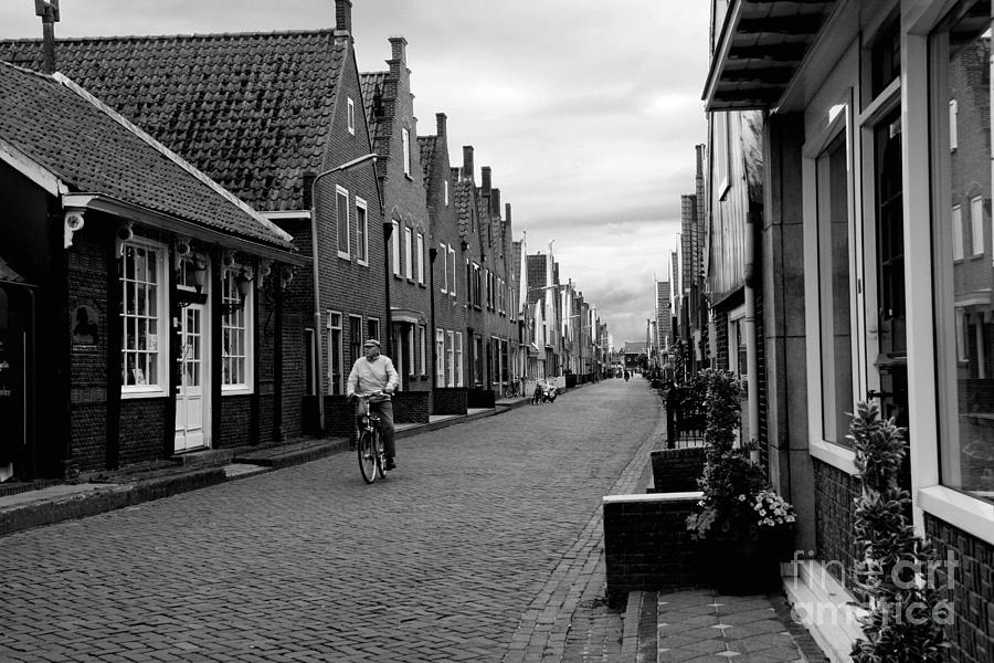Black And White Photograph - Cyclist in Volendam by Amy Bynum