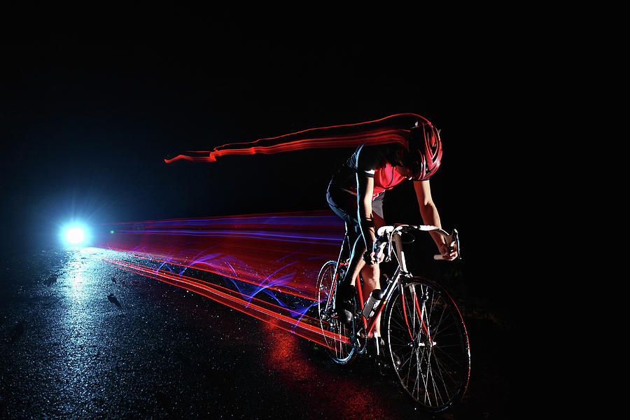 Cyclist Riding At Night Leaving Streaks Photograph by Stanislaw Pytel