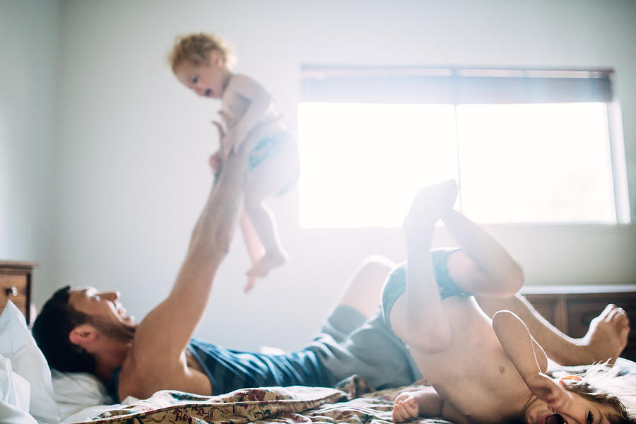 Dad and Kids Playing in Bedroom Photograph by RyanJLane