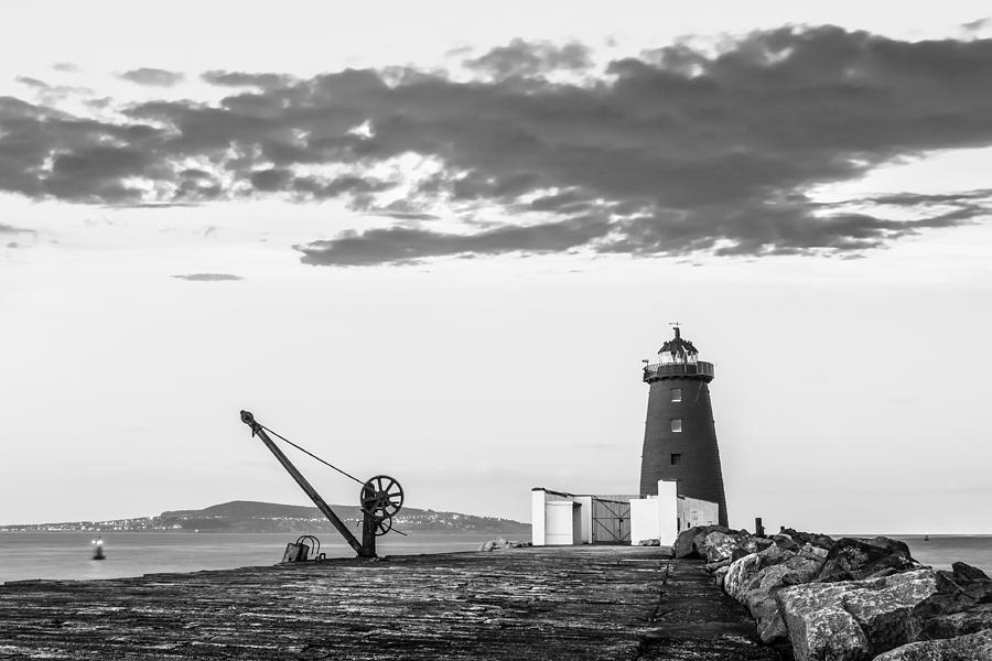 Davit and Lighthouse on a Breakwater Photograph by Semmick Photo