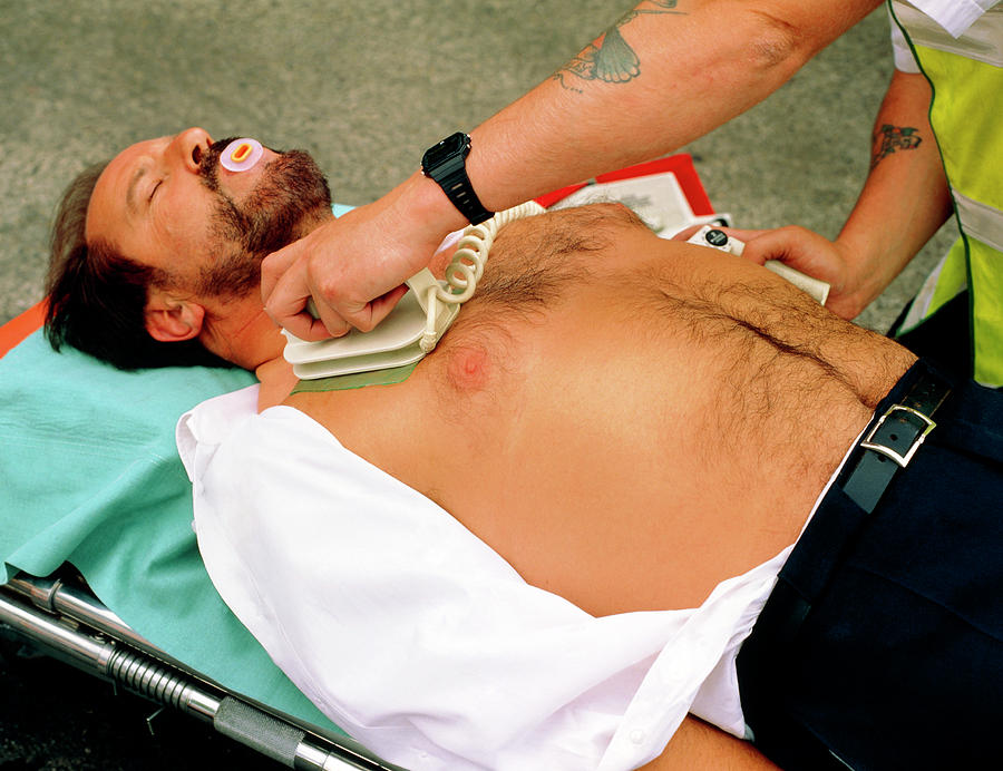 Defibrillator Used On Heart Attack Victim Photograph by Adam Hart-davis/science Photo Library