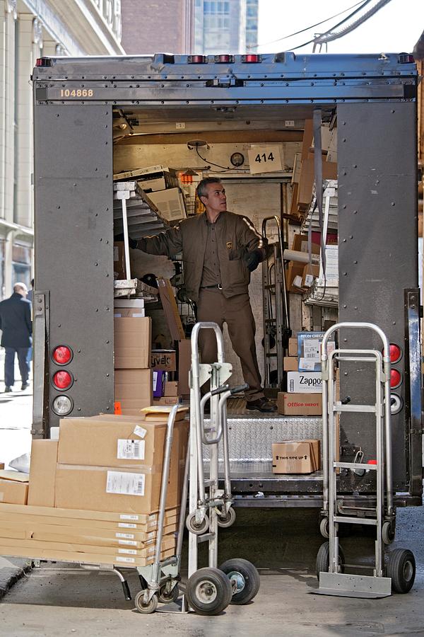 Detroit Photograph - Deliver Driver Loading His Van by Jim West