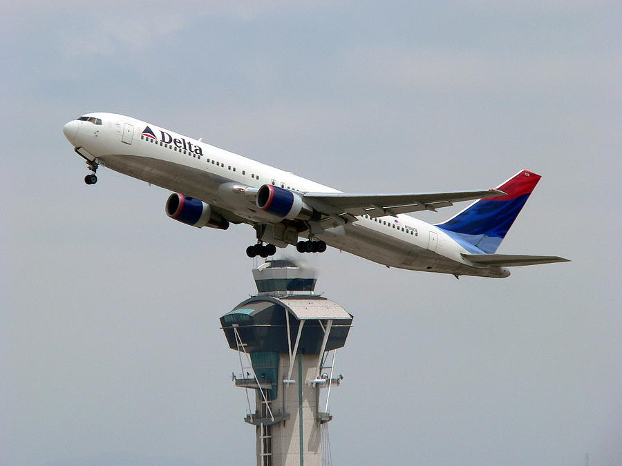 Delta Jet Flying Over LAX Tower Photograph by Jeff Lowe