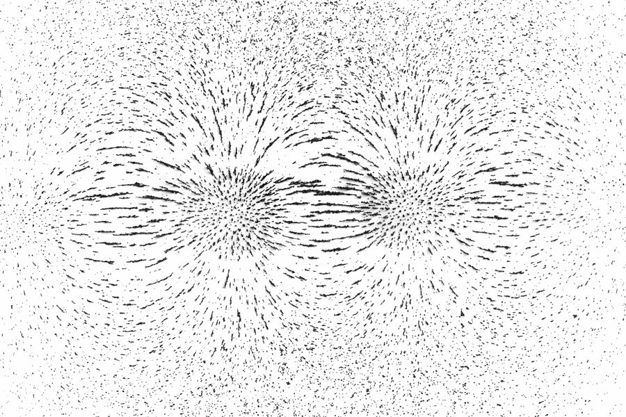 Demonstrating magnetic field lines of attracting poles using iron filings Photograph by StephanHoerold