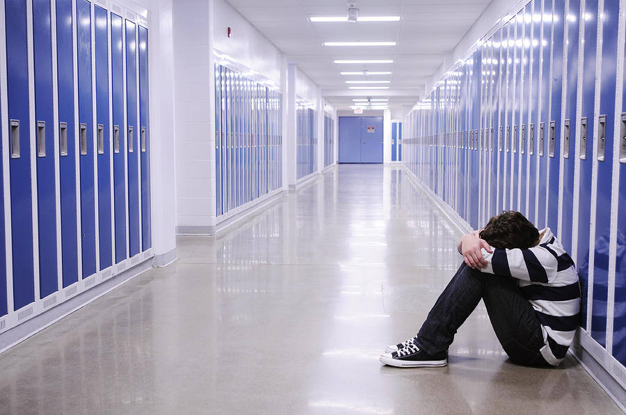 Depressed Boy in School Hallway Photograph by Stray_cat