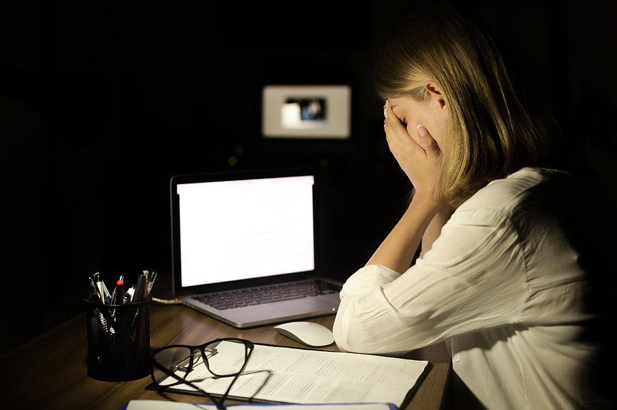 Depressed woman working with computer at night Photograph by Bymuratdeniz
