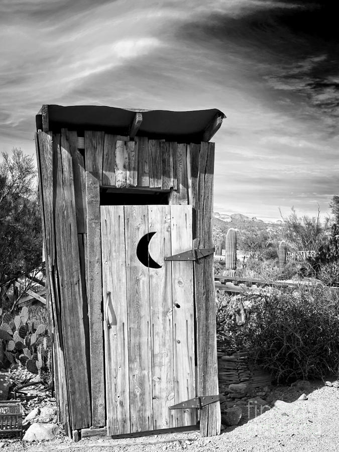 Black And White Photograph - Desert Outhouse Under Stormy Skies by Lee Craig