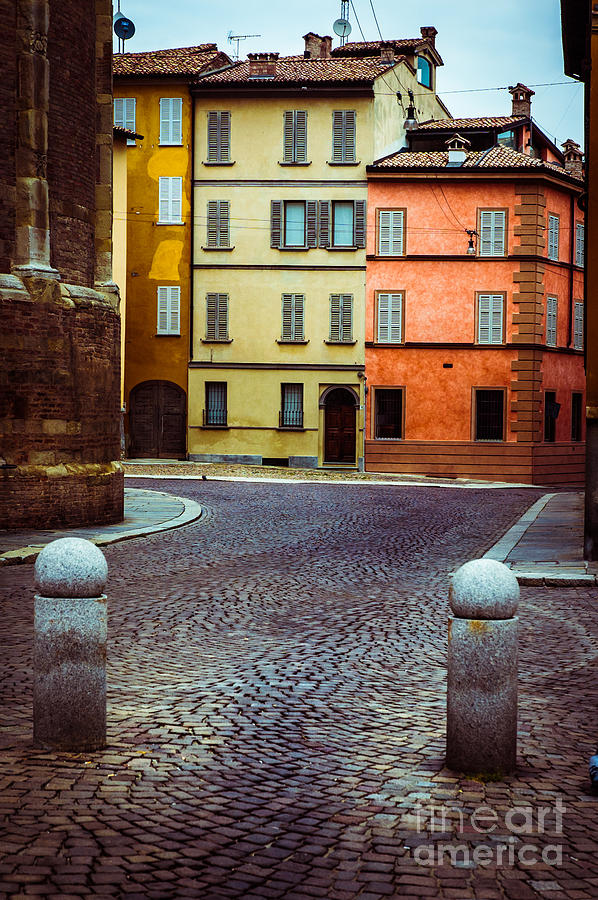 Cobbled Photograph - Deserted street with colored houses in Parma Italy by Silvia Ganora