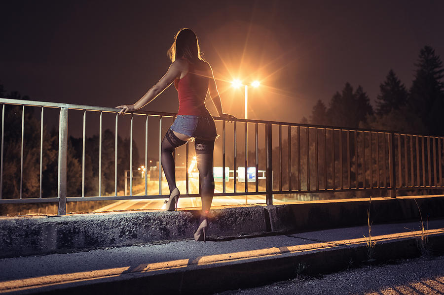 Desperate young woman standing on the bridge Photograph by Matjaz Slanic