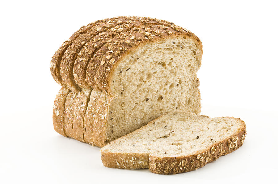Detailed close-up of sliced grain bread on white background Photograph by Fcafotodigital