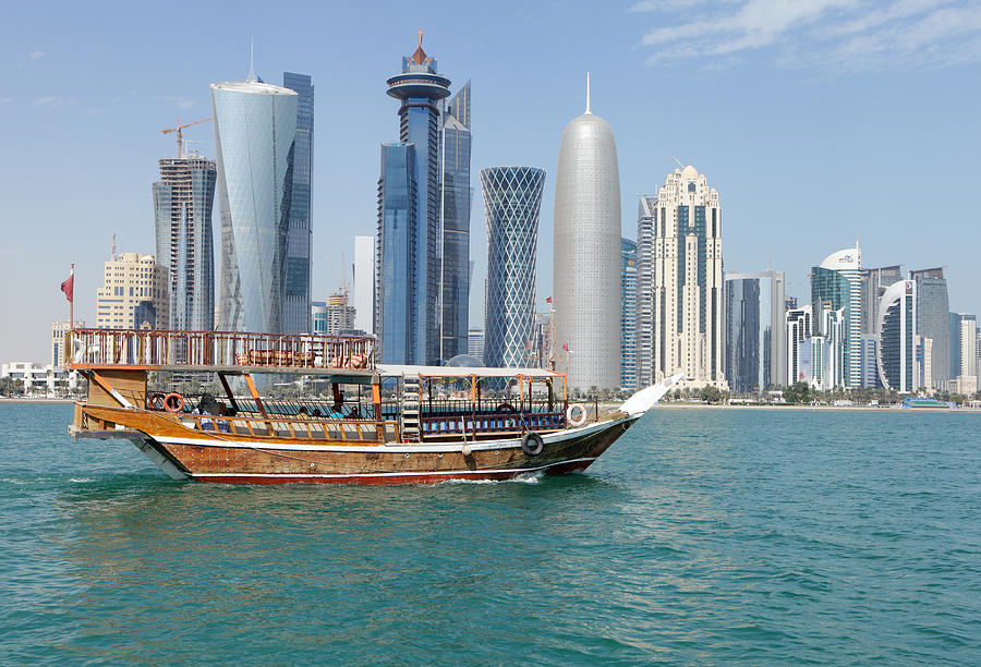 Dhow with towers and clouds Photograph by Paul Cowan