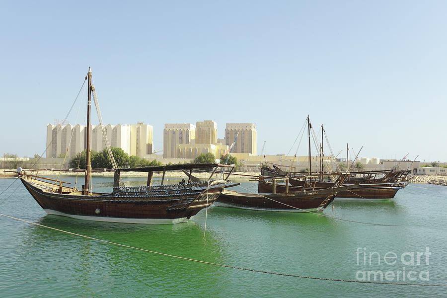 Dhows and Doha Port buildings Photograph by Paul Cowan