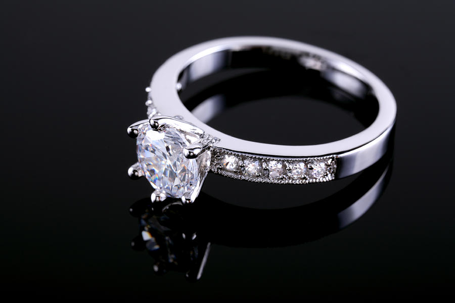 Diamond ring on a reflective surface Photograph by ProArtWork