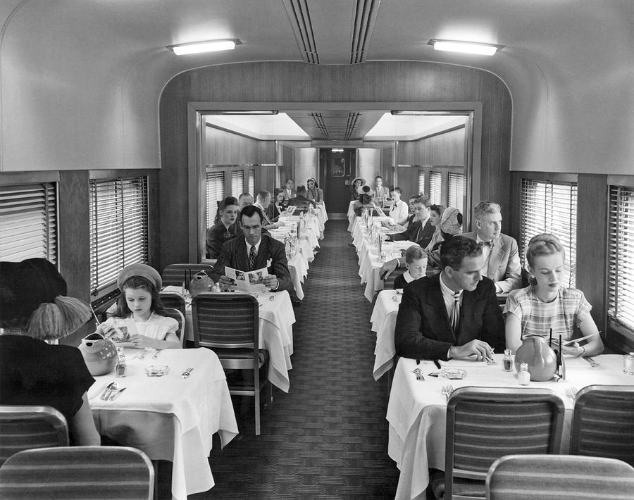 Black And White Photograph - Diners In Railroad Dining Car by Underwood Archives