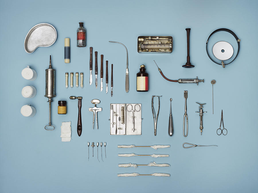 Directly above shot of medical tools on blue background Photograph by Nico Woehrle