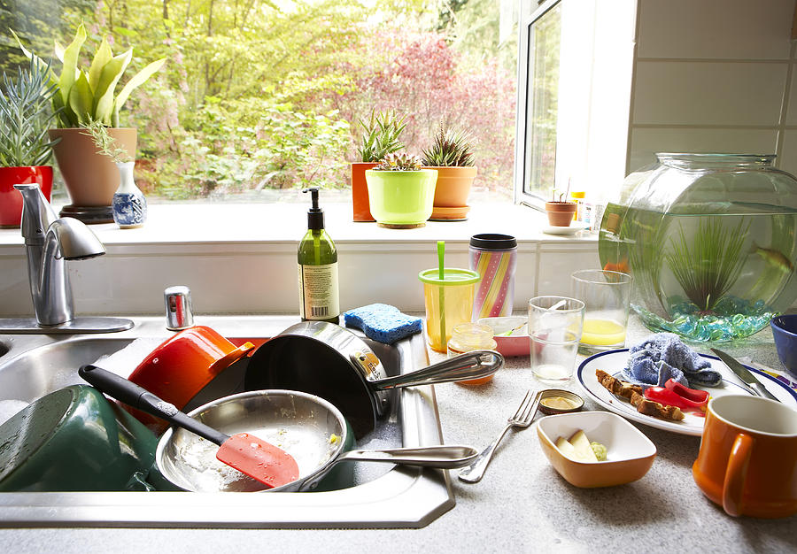 Dirty dishes piled in kitchen sink, close-up Photograph by Thomas Northcut