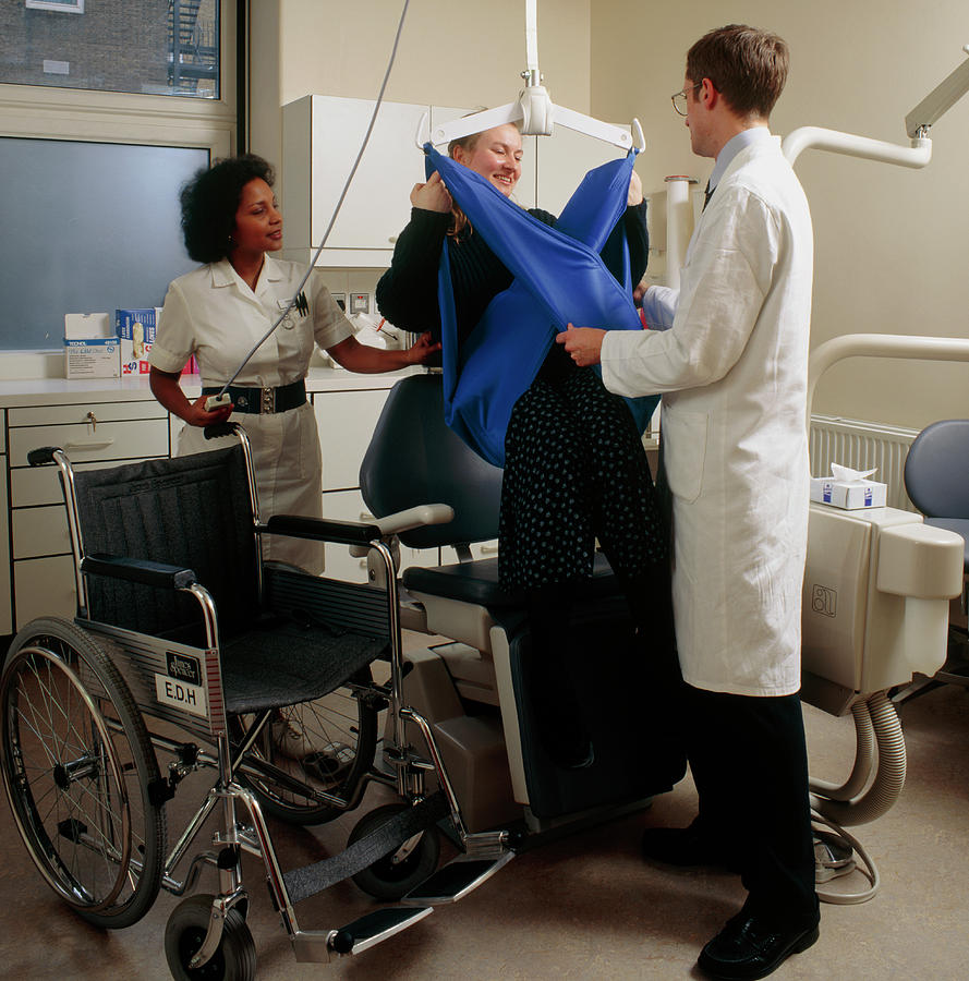 Disabled Woman Being Hoisted Into Dental Chair Photograph by Science Photo Library