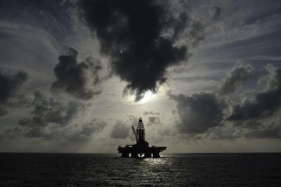 Distant offshore oil rig Photograph by Bradford Martin