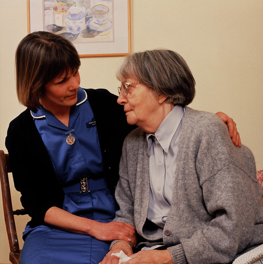 District Nurse Comforts An Elderly Patient Photograph by Chris Priest/science Photo Library
