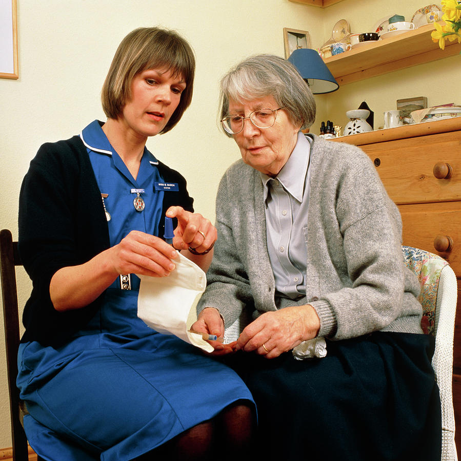 District Nurse Explains Use Of Urine Bag To Woman Photograph by Chris Priest/science Photo Library