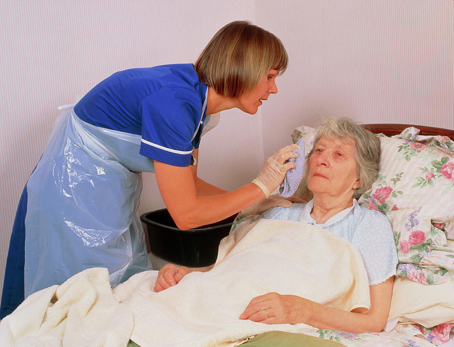 District Nurse Gives Elderly Patient A Bed Bath Photograph By Chris