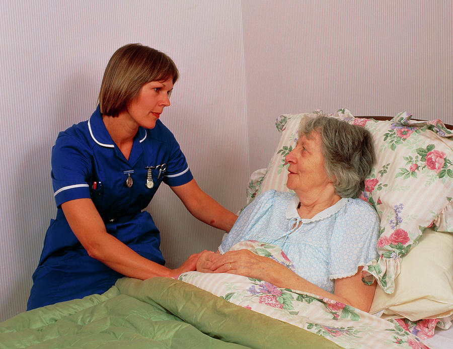 District Nurse Talks To Elderly Bedridden Patient By Chris Priest