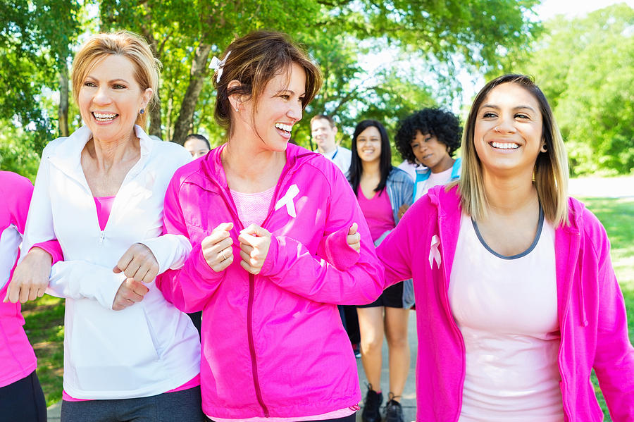 Diverse women walking in breast cancer awareness marathon race Photograph by Steve Debenport