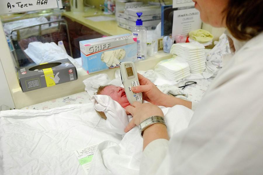 Newborn Photograph - Doctor Examines A Newborn by Photostock-israel