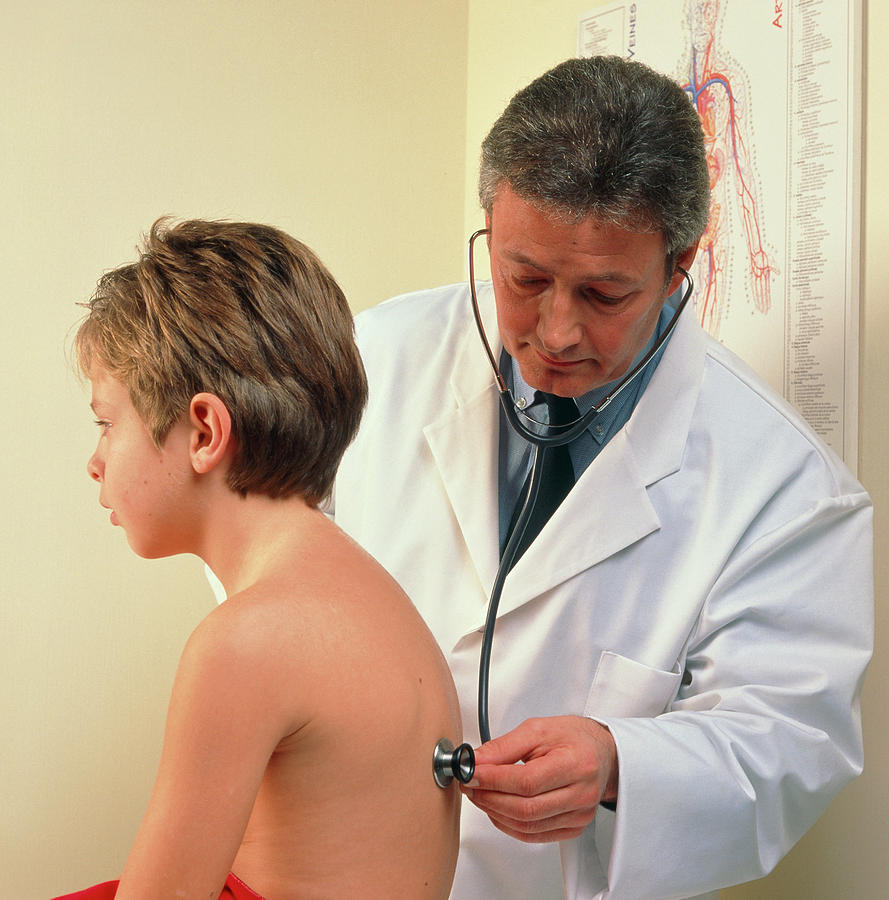 Doctor Examines Boys Chest With A Stethoscope Photograph by Cc Studio/science Photo Library