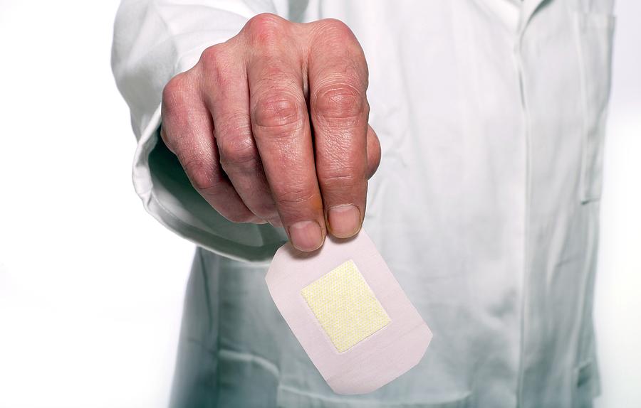 Doctor Holding A Plaster Photograph by Victor De Schwanberg