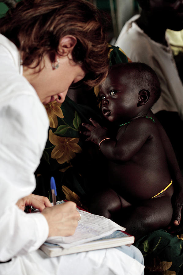 Doctor In A Ugandan Refugee Camp Photograph by Mauro Fermariello/science Photo Library